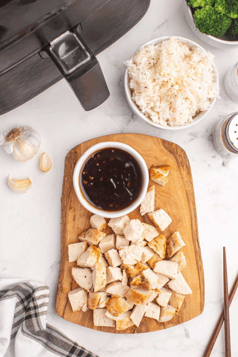 Serving teriyaki miso sauce over noodles with vegetables and sesame seeds.