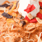 Bowl of creamy Ruby Tuesday white chicken chili topped with cheese and cilantro.