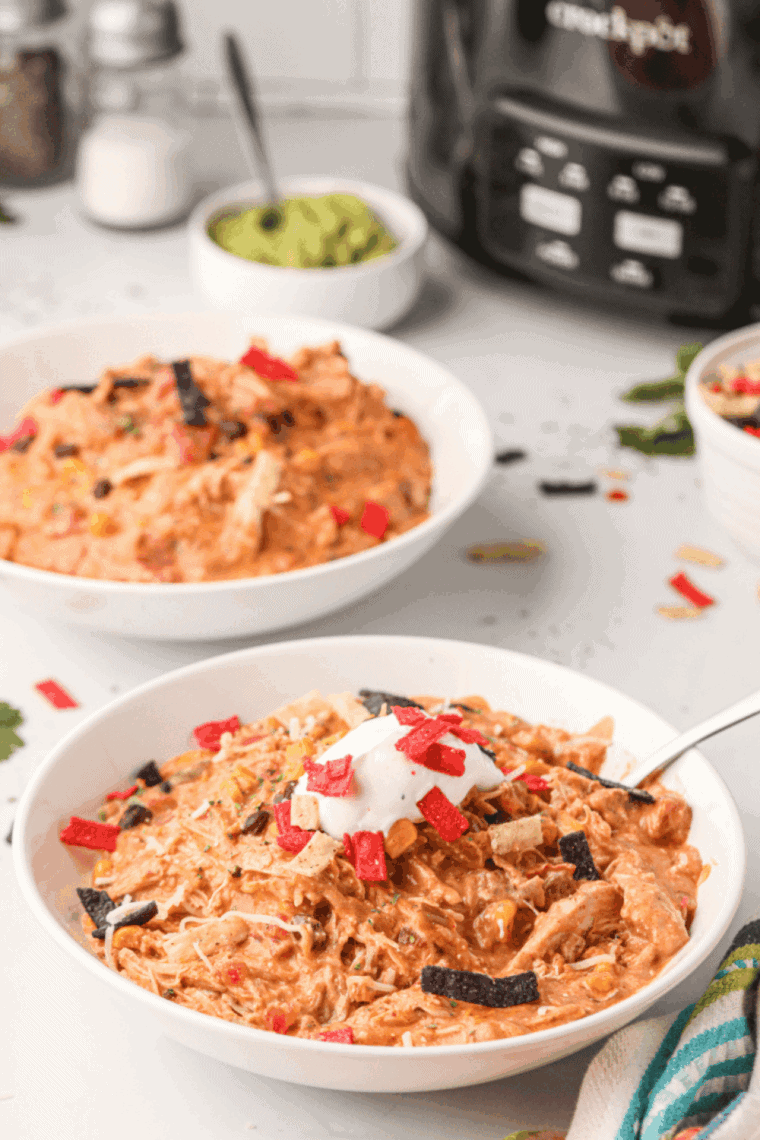 Bowl of creamy Ruby Tuesday white chicken chili topped with cheese and fresh cilantro.