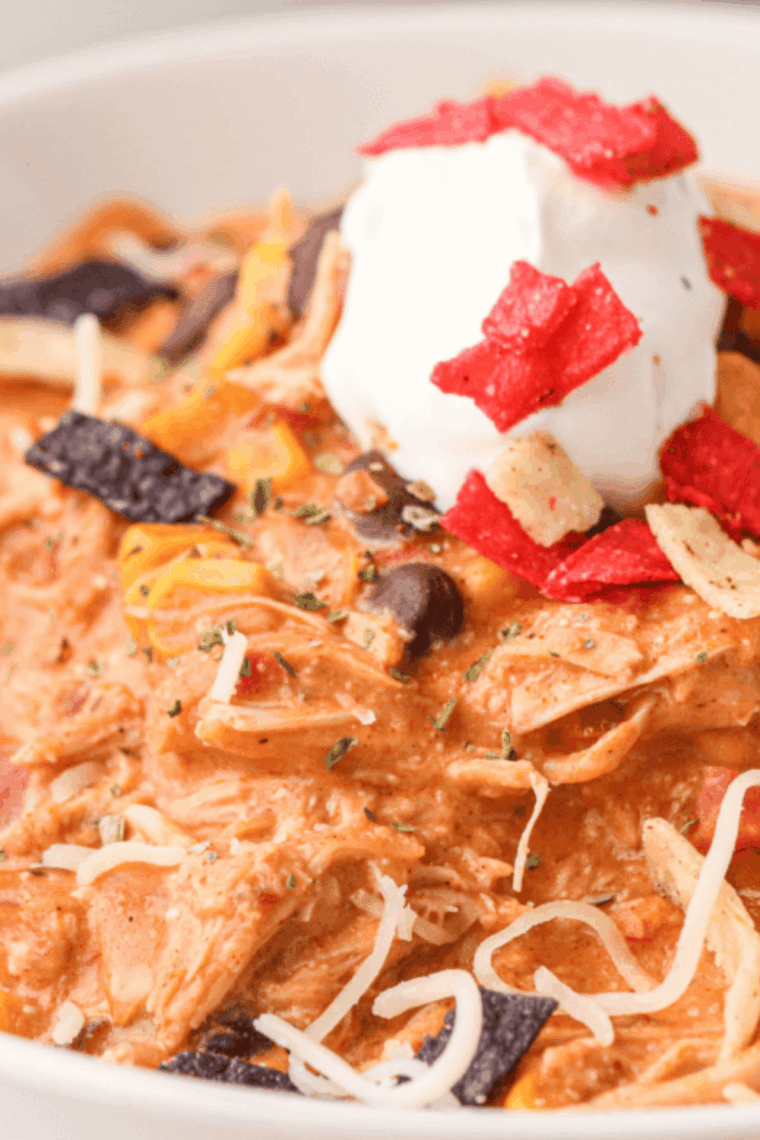 Bowl of creamy Ruby Tuesday white chicken chili topped with cheese and cilantro.