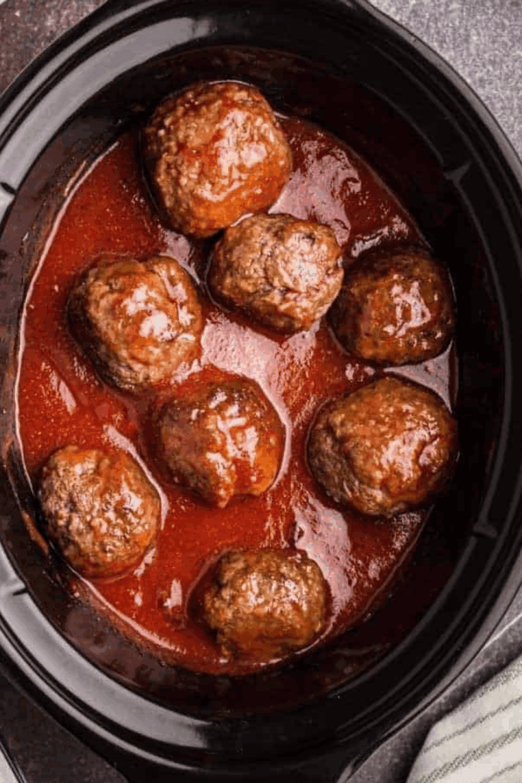 slow cooker marinara sauce made with tomatoes, garlic, herbs, and onions simmering in a crockpot