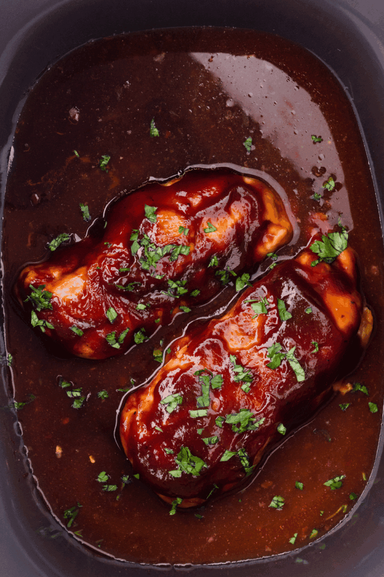 Slow Cooker Sweet Baby Ray’s Chicken served shredded with rich, glossy BBQ sauce.
