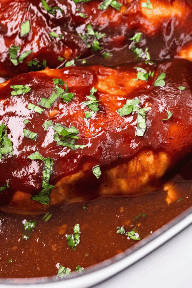 Chicken breasts placed evenly in the slow cooker before cooking.