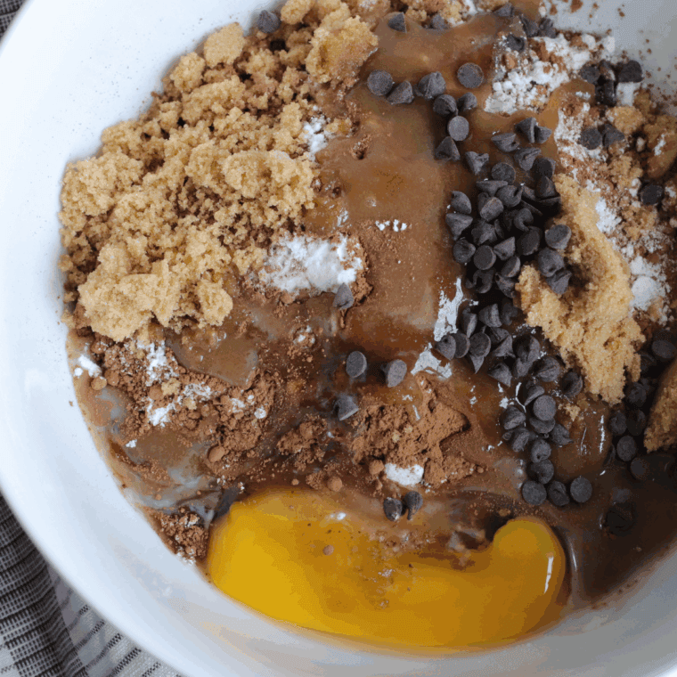 Cocoa powder, flour, baking soda, baking powder, and salt whisked in a separate bowl before folding into wet mixture.