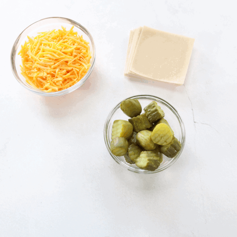 Ingredients needed for Air Fryer Crispy Pickle & Cheese Filled Wontons on kitchen table.