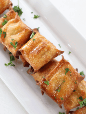 Golden crispy air fryer wontons stuffed with melted cheese and tangy pickles