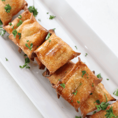 Golden crispy air fryer wontons stuffed with melted cheese and tangy pickles