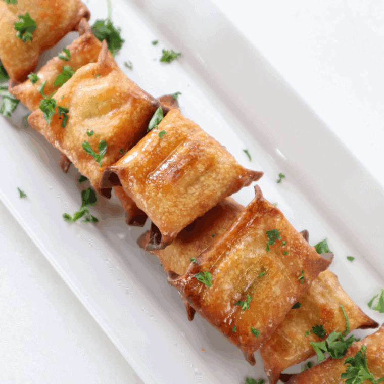 Golden crispy air fryer wontons stuffed with melted cheese and tangy pickles