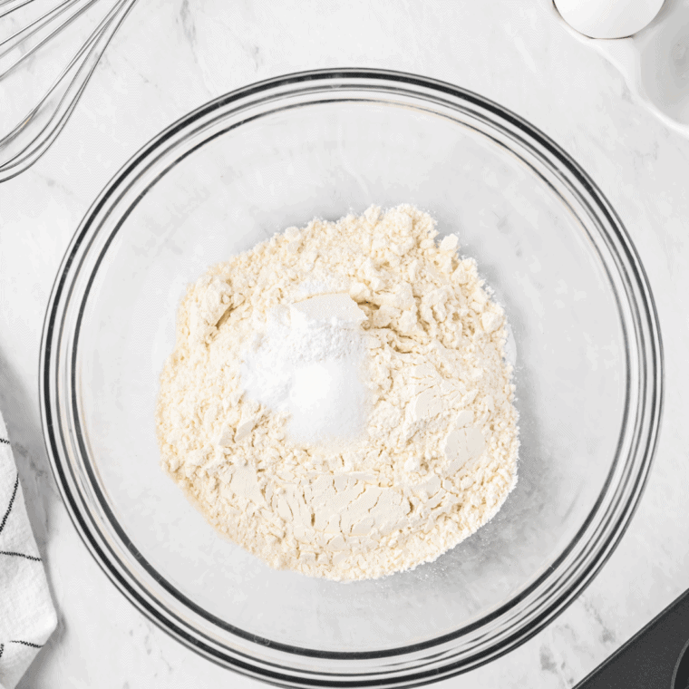 Whisking flour, sugar, baking powder, salt, and cinnamon in a large bowl for donut batter