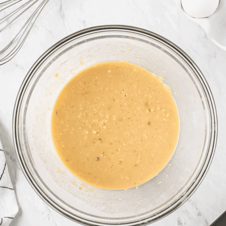 Mixing milk, melted butter, and vanilla extract in a separate bowl