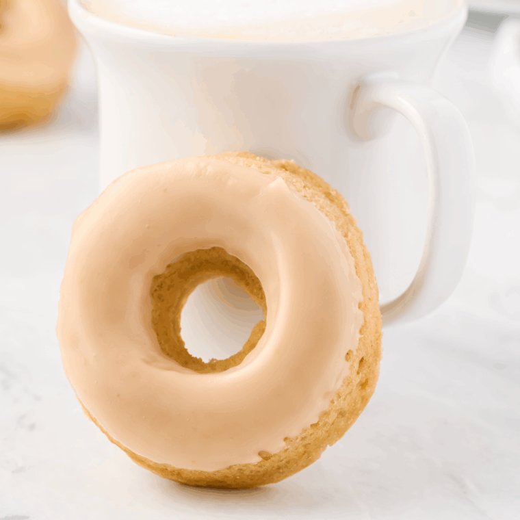 Freshly made eggless air fryer donuts with a golden exterior and soft, fluffy center.