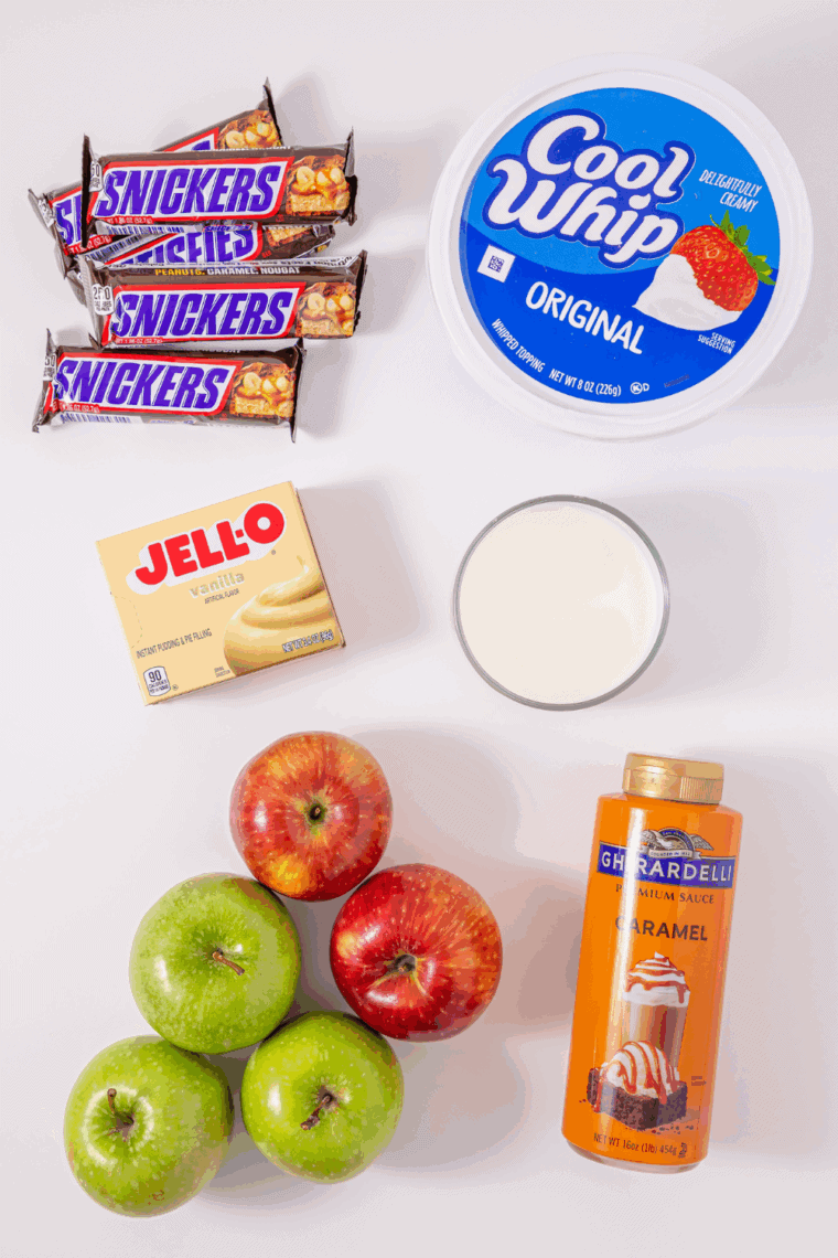 Ingredients needed for Easy Candy Bar Apple Salad Recipe on kitchen table.