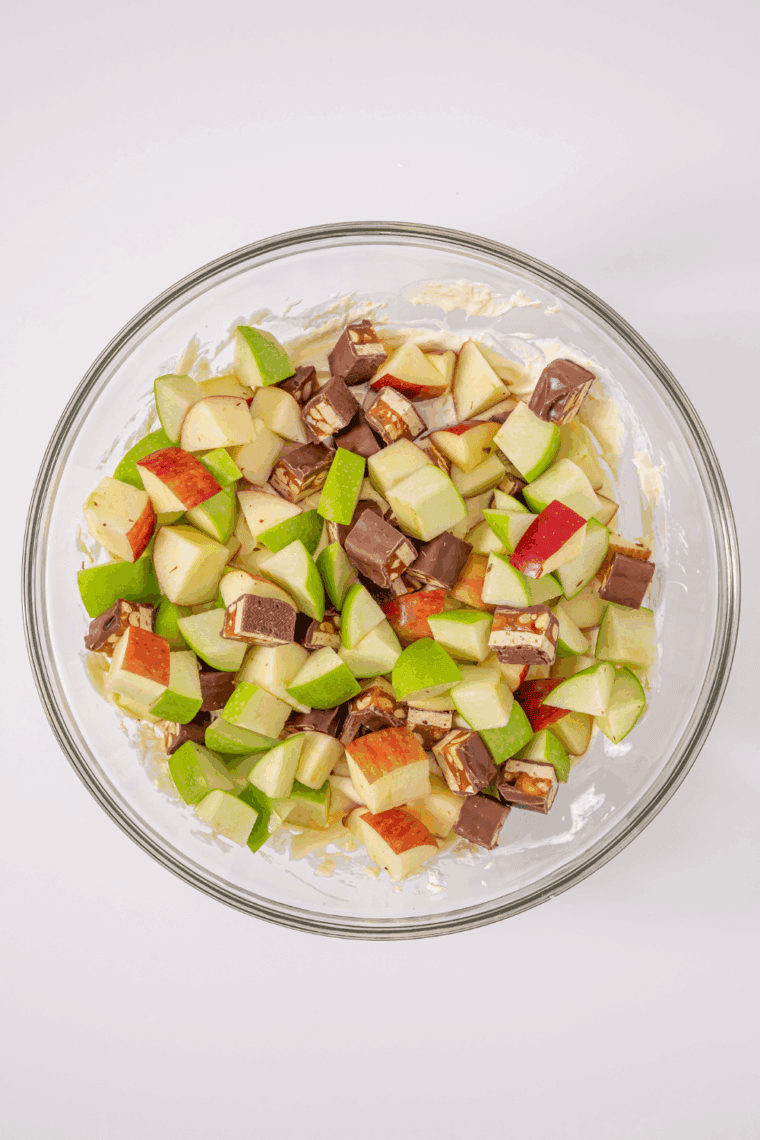 Dice apples and Snickers bars into bite-sized pieces and mix into the pudding mixture.