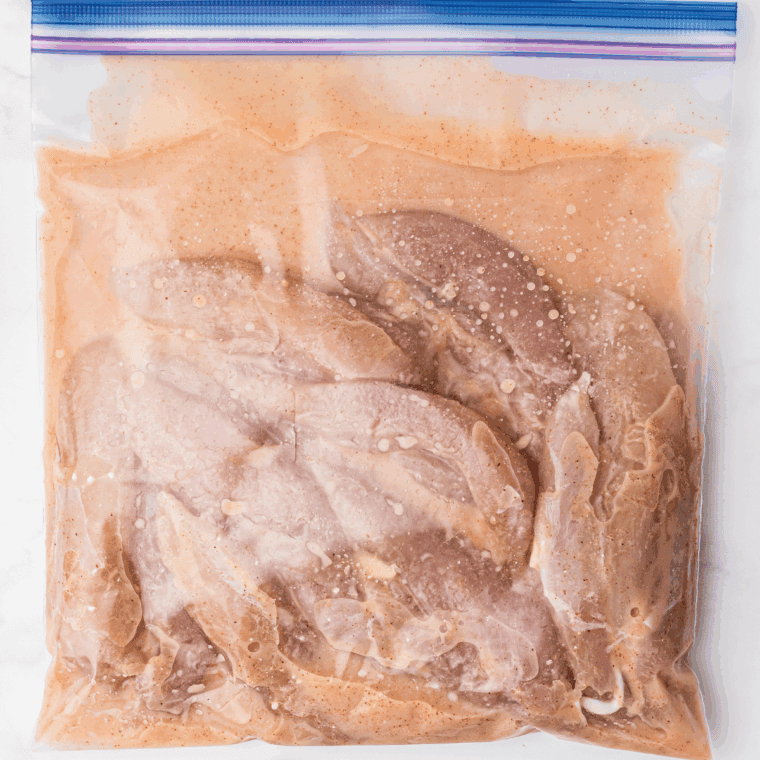 Patting chicken tenders dry with paper towels before breading