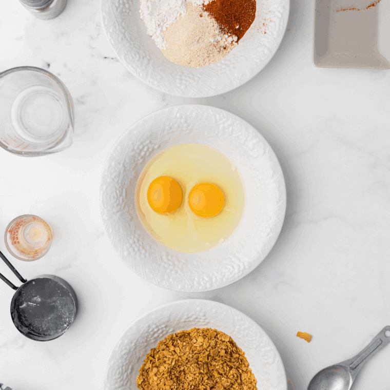 Breading station with flour, egg mixture, and seasoned breadcrumbs
