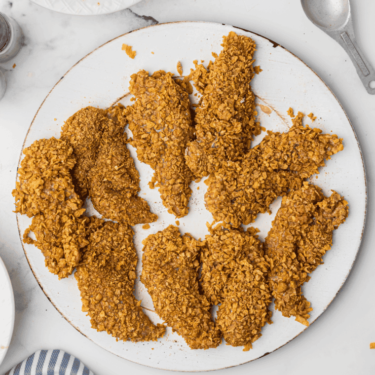 Preheating air fryer basket sprayed with cooking spray