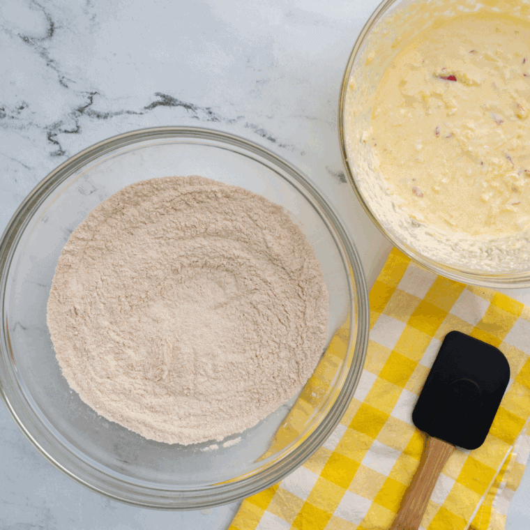 Mixing dry ingredients in one bowl and wet ingredients in another to prepare soft donut dough.