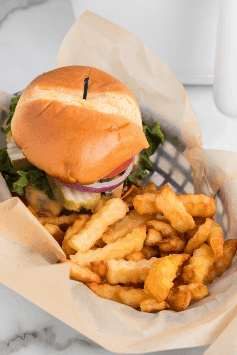 Close up with butter burger with signature sauce layered on top.