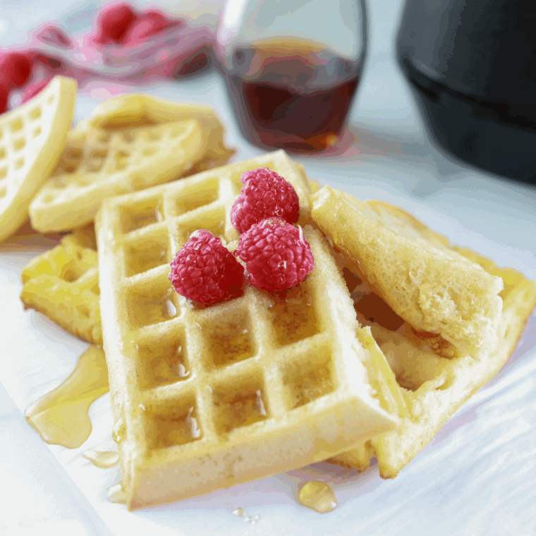 Freshly cooked First Watch-style waffle served on a plate with syrup and butter