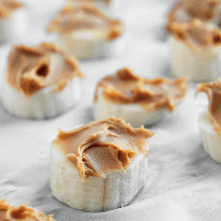 Spread a small amount of peanut butter on each banana slice evenly.