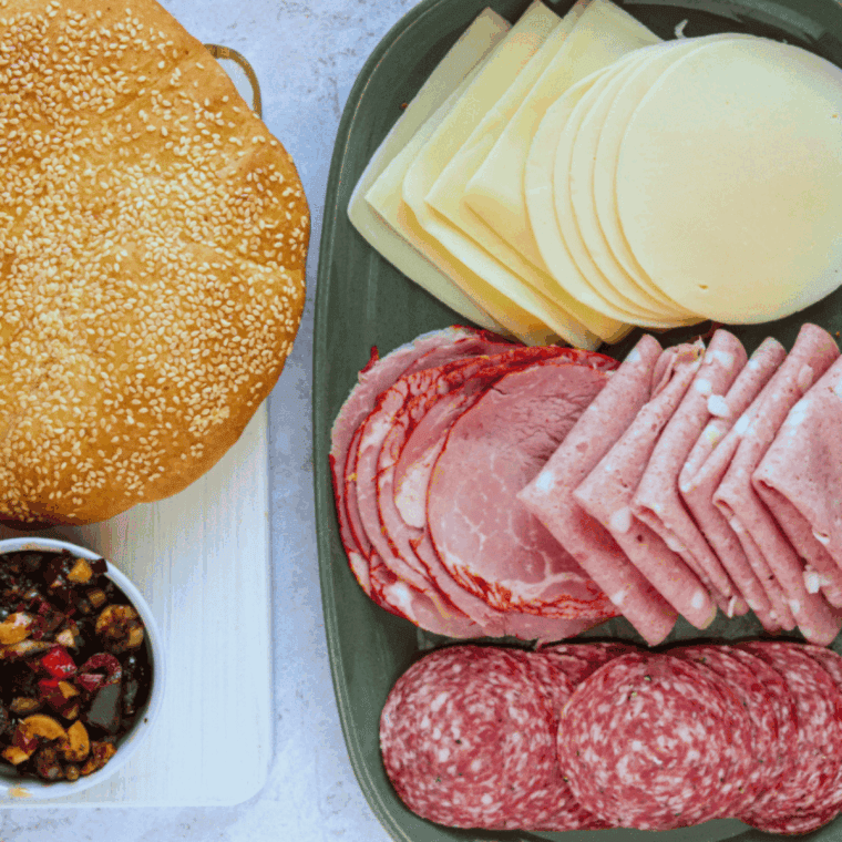 Ingredients needed for Easy Jason's Deli Muffuletta Recipe on kitchen table.