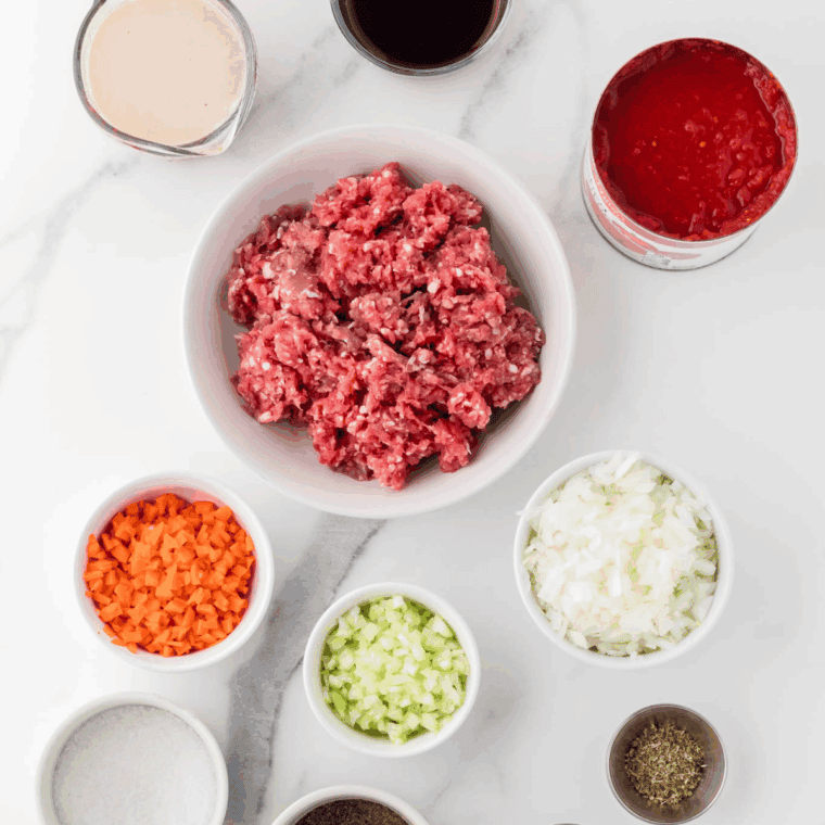 Ingredients needed for Easy Olive Garden Bolognese Sauce on kitchen table.
