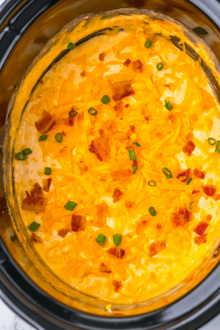 Smooth, creamy beer cheese dip stirred and kept warm in the slow cooker, ready to serve.