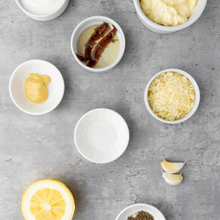 Ingredients needed for Easy Spicy Caesar Dressing on kitchen table.