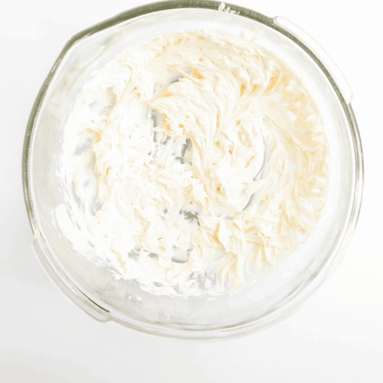 Whipping cream cheese until smooth and creamy in a large bowl.