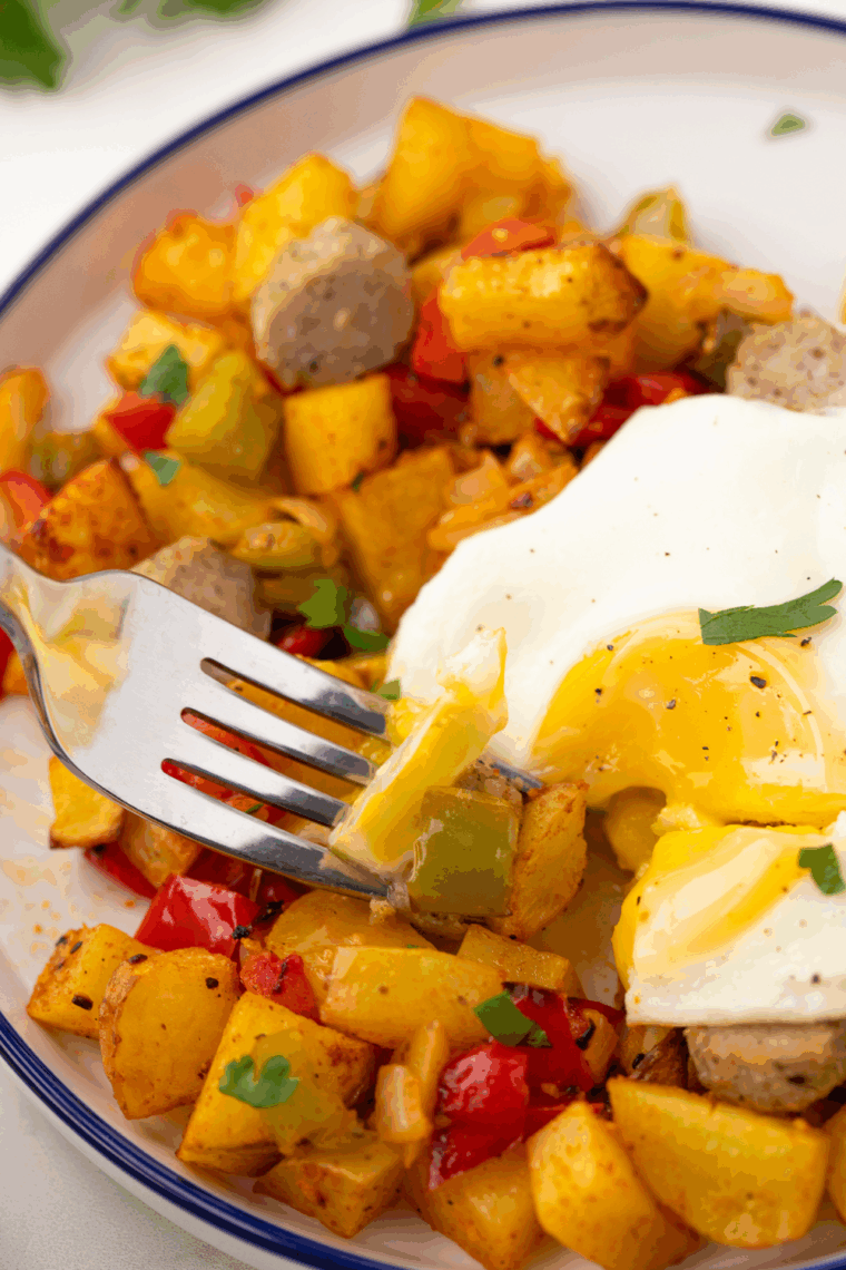 First Watch Copycat Market Hash with golden potatoes, saut&eacute;ed chicken, bell peppers, onions, mushrooms, and fresh spinach in a skillet, ready to serve.