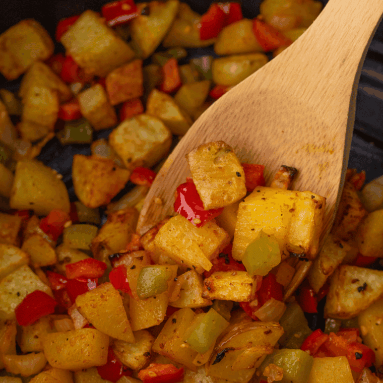 Push vegetables and potatoes aside, cook chicken until golden and no longer pink, then mix everything together evenly.