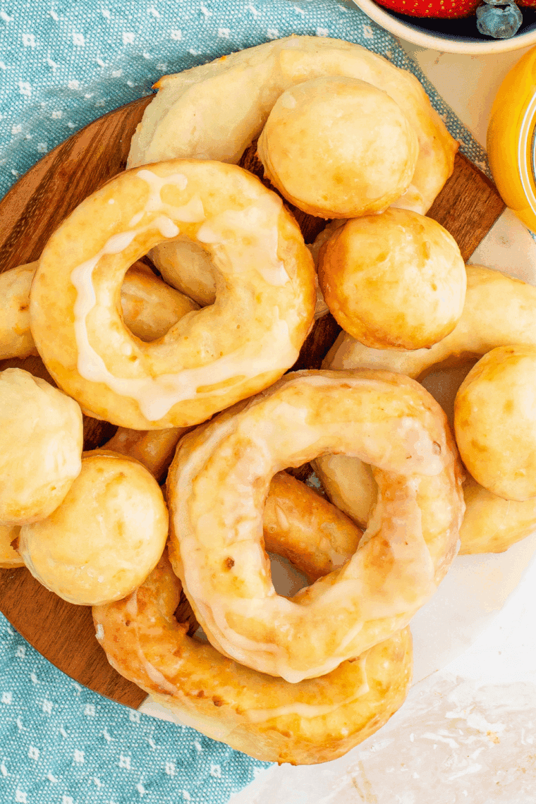 Plate of golden air fryer sourdough discard donuts with glaze