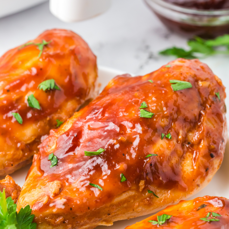 Spoonful of homemade hot honey BBQ sauce drizzling back into a jar