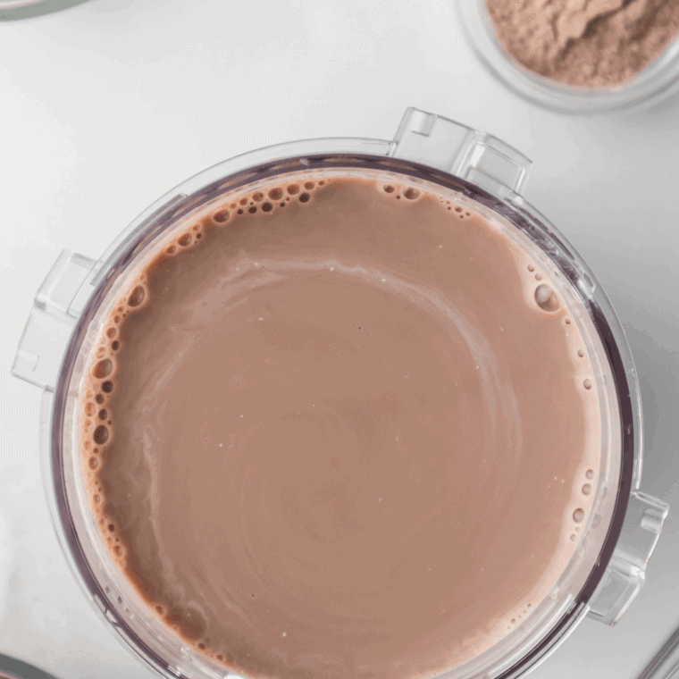 In a bowl, combine whole milk, heavy cream, chocolate shake powder, and chocolate syrup until smooth.
