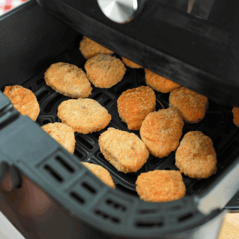 Arranging frozen Tyson chicken nuggets in air fryer basket