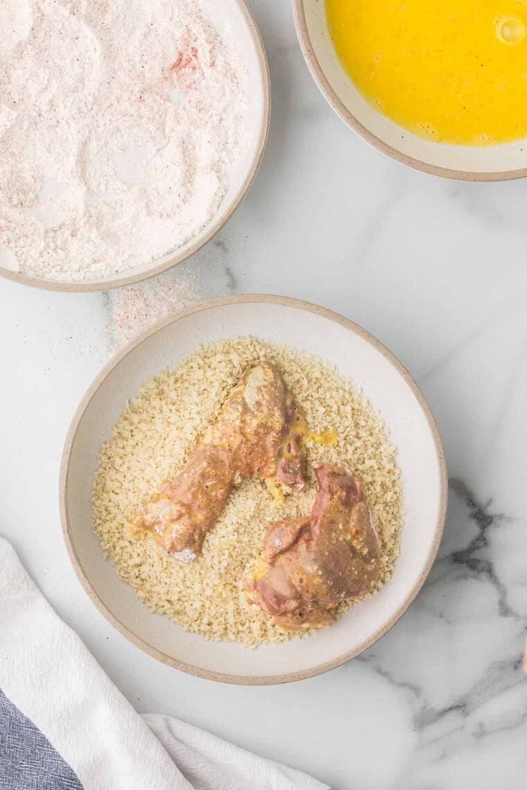 Coat the Livers: Chicken livers being dredged in flour, dipped in eggs, then coated with breadcrumbs.
