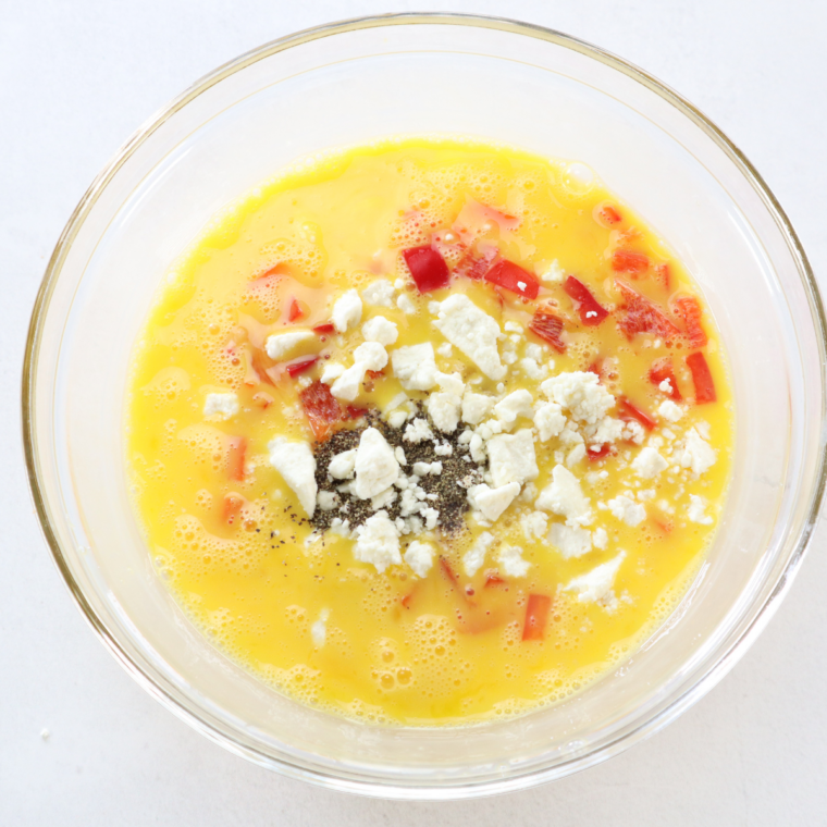 Whisking egg whites, milk, salt, and pepper in a bowl until smooth