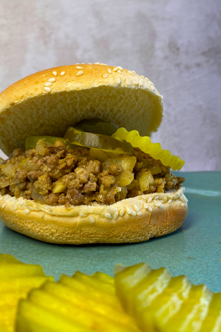 Air fryer copycat Maid-Rite sandwich with seasoned ground beef on a soft bun, served ready to eat.