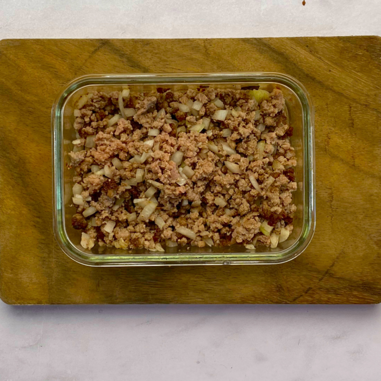 Cooked ground beef on kitchen countertop, in a glass oven safe bowl.