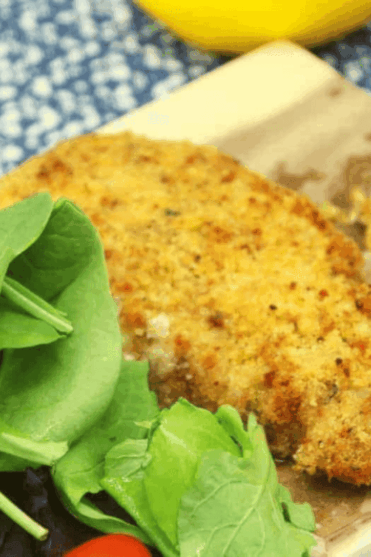 Golden panko-crusted cod cheeks served on a plate with lemon wedges