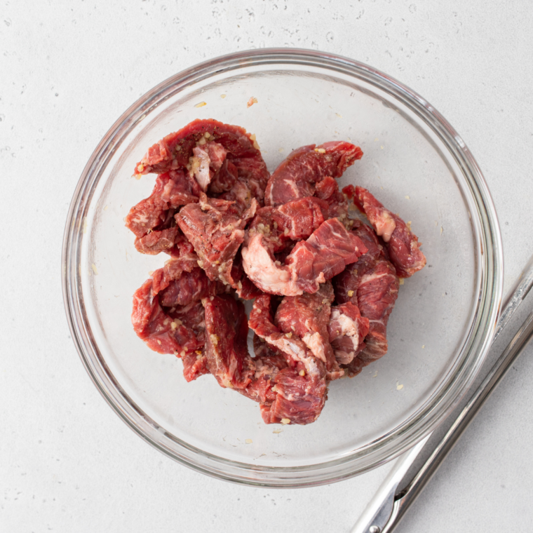 Flank steak sliced into strips and tossed with garlic, ginger, salt, and pepper