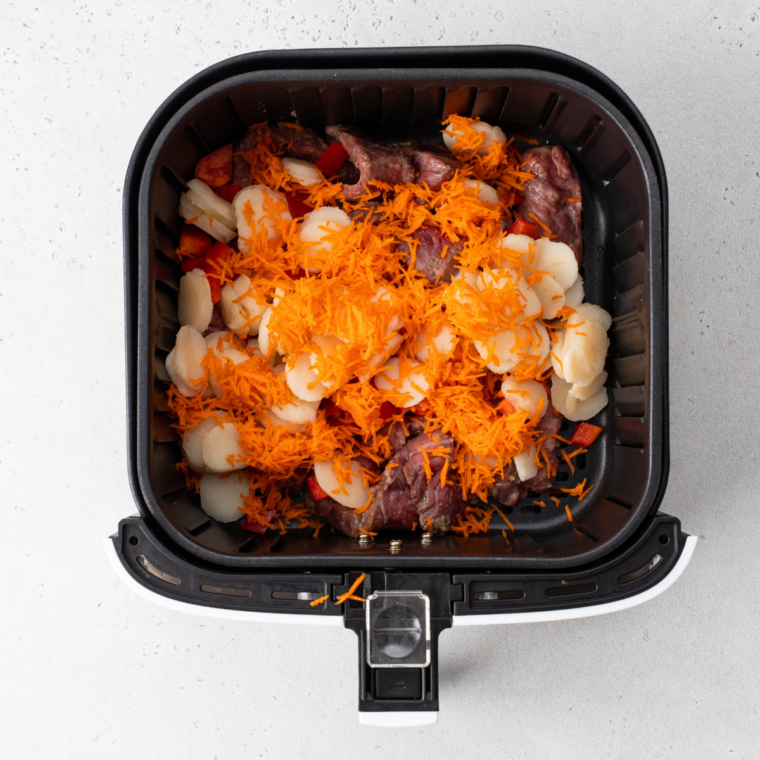 Cooked beef and vegetables mixed with noodles and broccoli, tossed with sauce