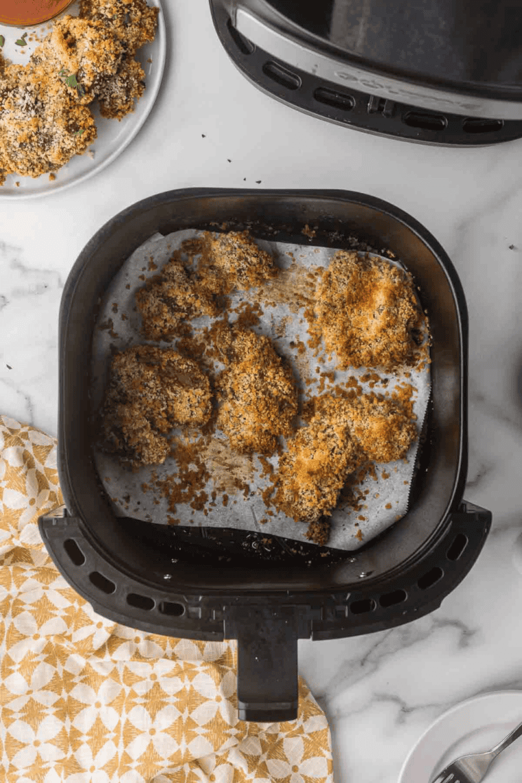 Cook the Livers: Breaded chicken livers arranged in a single layer in the air fryer cooking.