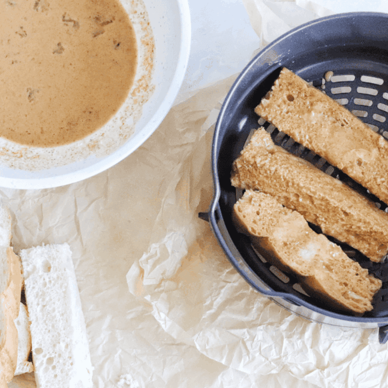 Tossing bread cubes in egg mixture to coat evenly