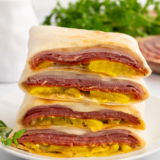 Air Fryer Hot Italian Wraps with melted cheese, Italian meats, and crispy golden tortilla on a plate.