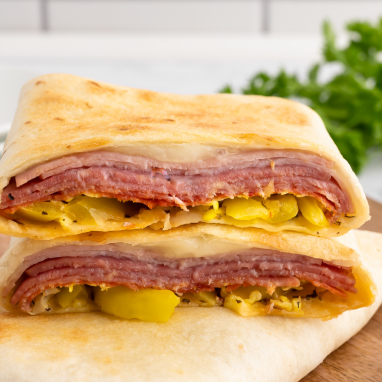 Air Fryer Hot Italian Wraps on a plate, golden and crispy, filled with melted cheese, Italian deli meats, and seasoned veggies.