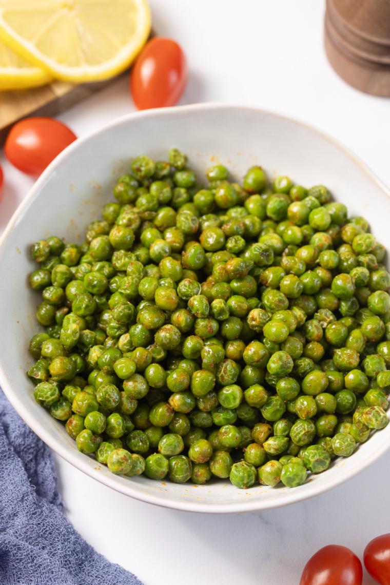 Golden crispy air fryer wasabi peas served in a bowl, coated with spicy seasoning