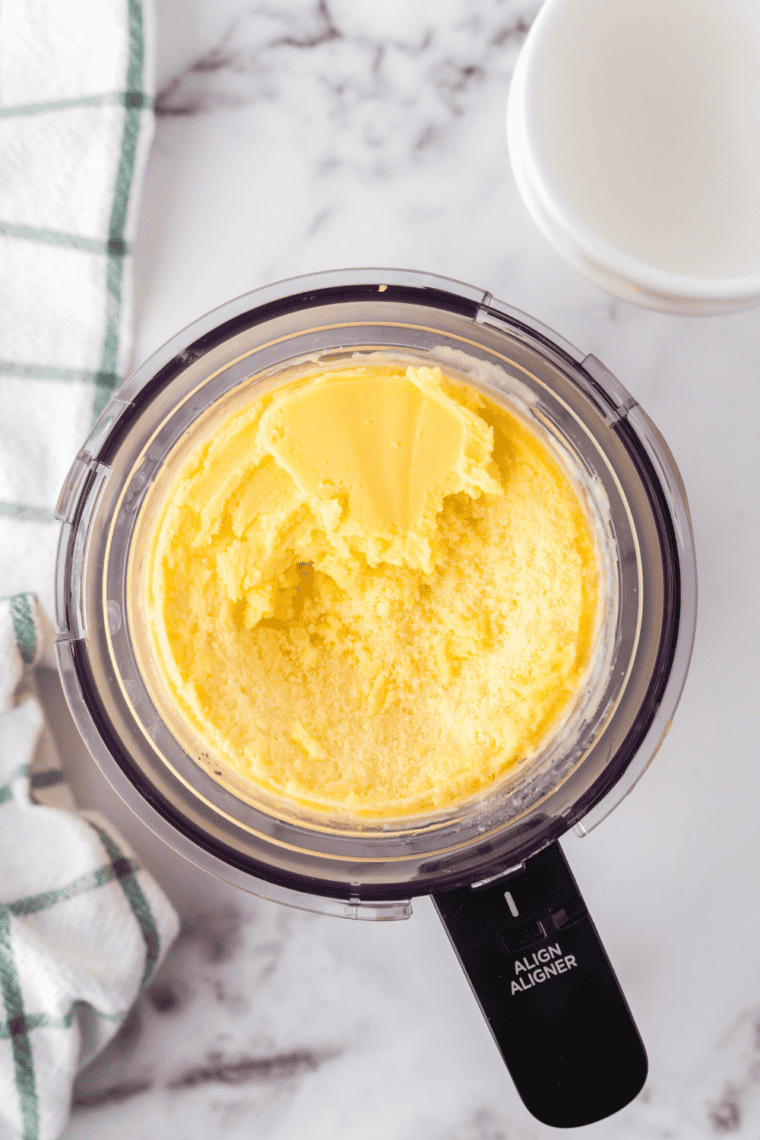 Frozen mango gelato pint in the Ninja Creami machine being processed on Gelato setting.