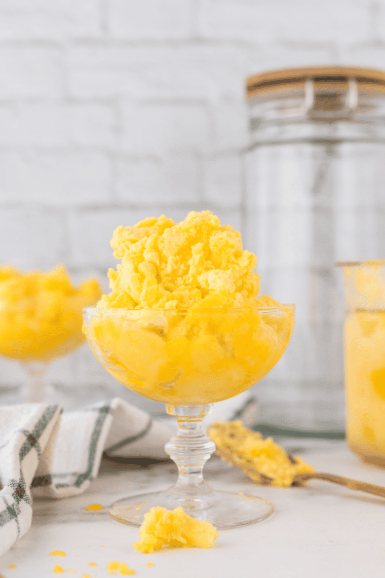Bowl of creamy Easy Ninja Creami Mango Gelato garnished with fresh mango pieces, ready to enjoy.