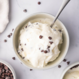 Creamy Ninja Creami stracciatella gelato in a bowl with chocolate flakes throughout.